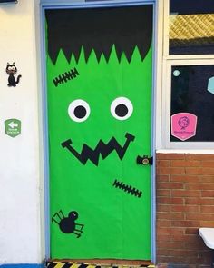 a green door decorated to look like a monster