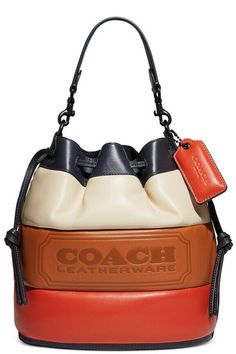 From weekdays to fun-filled weekends, the Field Bucket Bag from COACH includes a lightweight strap to wear as a crossbody. 8-3/4"W x 9-3/4"H x 5-1/2"D (width is measured across the bottom of handbag) Silhouette is based off 5'9" model 5-3/4"L handle; 24-1/2"L detachable crossbody strap Drawstring closure Exterior hangtag, protective feet Interior zip pocket Leather Wipe clean Includes dust bag  Brand new in original packaging Coach 1941, Webbing Strap, Leather Bucket Bag, Leather Bucket, Bago, Embossed Leather, Smooth Leather, Coach Bags, Top Handle