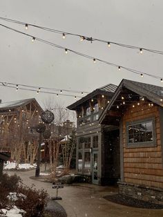 the outside of a building with lights strung from it