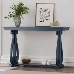 a blue console table with a plant on top