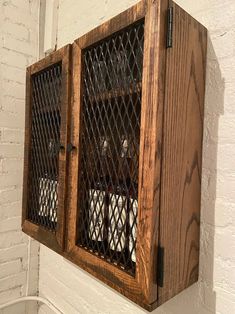 two dogs are sitting in their kennels on the wall