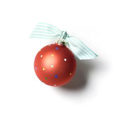 a red ornament hanging from a green ribbon