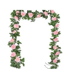 pink roses and greenery are arranged in the shape of a letter