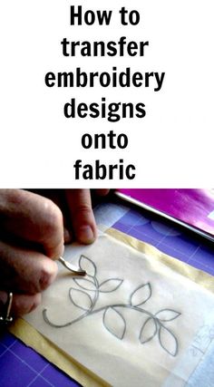 someone is cutting fabric with scissors on a piece of paper that says how to transfer embroidery designs onto fabric