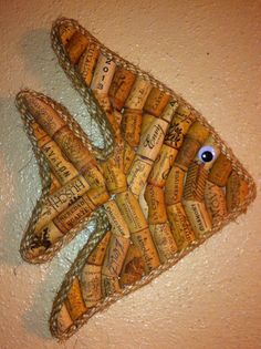 a fish made out of wine corks on the wall