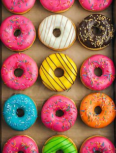 a box filled with lots of different flavored donuts