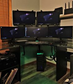 several computer monitors sitting on top of a desk