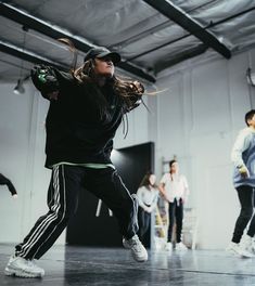 a group of young people dancing in a dance studio