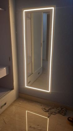 a bathroom with a mirror and lights on the wall