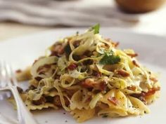 a white plate topped with pasta covered in sauce