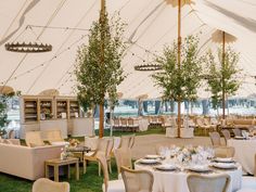 tables and chairs are set up in a large tent