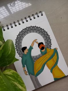 a spiral notebook with an image of two men dancing