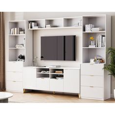 a white entertainment center with bookshelves and shelves in the middle, along with a television on top