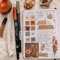 an open notebook sitting on top of a table filled with lots of different types of items