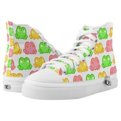 a pair of white high top sneakers with colorful elephants on them, all over print