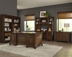 an office desk and bookcases in a room