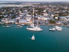 an aerial view of boats in the water and buildings around them, including a sailboat