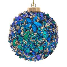 a blue ornament hanging from a gold chain on a white background with lots of beads