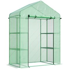 a walk in greenhouse with green netting on the side and shelves for plants inside it