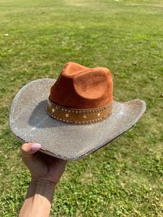 Brown print hat with champagne gold  rhinestones on the top brim. Silver tiny stars on the bottom and some around the crown brim  This is one size fits most, there's a drawstring to adjust sizing.  ships in 2 business days! Stunning in person  Perfect for Halloween , Barbie costume, Coachella , stagecoach, Nashville, country concerts, bachelorette parties, brides, weddings Please note that the hats are handmade and may have some variances and blemishes. If any, they are very minor . The hats might have a bit of "stickiness" from the glue setting the rhinestones, this will improve over time. Halloween Barbie Costume, Rhinestone Cowgirl Hat, Halloween Barbie, Nashville Country, Rhinestone Cowgirl, Barbie Costume, Cowgirl Hat, Country Concerts, Tiny Star