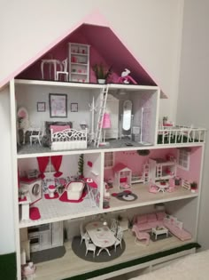 a doll house with all the furniture and accessories in it's pink color scheme