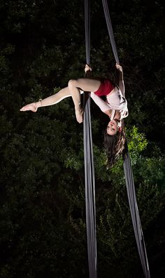 a woman is hanging upside down in the air