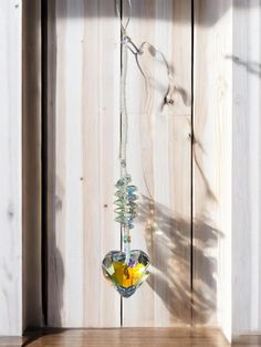 a bird feeder hanging from the side of a wooden wall