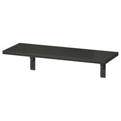 a black shelf sitting on top of a white wall in front of a white background