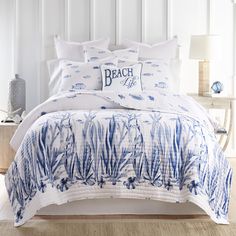 a bed with blue and white comforters in a bedroom