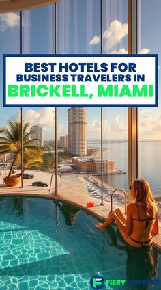 a woman sitting on the edge of a swimming pool in front of a large window that reads best hotels for business travelers in brickell, miami