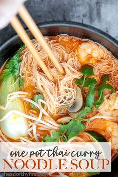 someone is holding chopsticks over a bowl of noodles and shrimp soup with vegetables