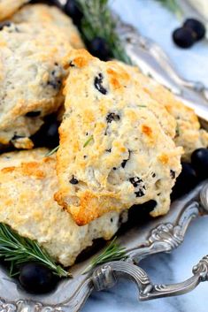 biscuits with black olives and rosemary on a silver platter, ready to be eaten