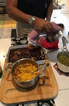 a person preparing food in a kitchen on a cutting board with other dishes and utensils