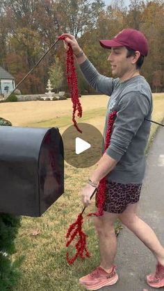 a man is pulling string from his mailbox