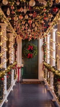 christmas decorations adorn the front door of this home, decorated with garland and lights