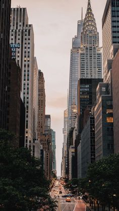 an empty city street with tall buildings in the background