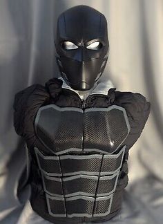 a man in a black mask and leather outfit