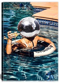 a woman wearing a disco ball helmet in a pool