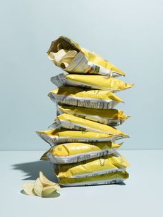 a stack of chips sitting on top of each other next to a bag of chips