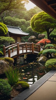 a small bridge over a pond in a japanese garden