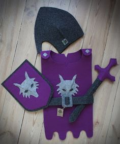 two pieces of felt are laid out on the floor, including a hat and gloves