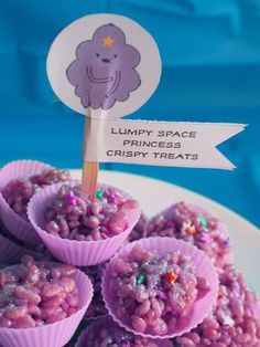 purple desserts with sprinkles and a sign that says lumpy space