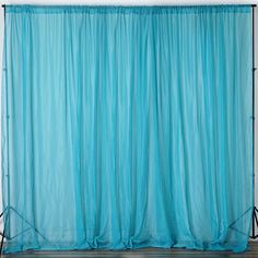 a blue curtain is hanging in front of a white wall