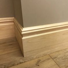 the corner of a room with wood flooring