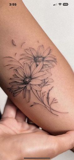 a woman's arm with flowers on it