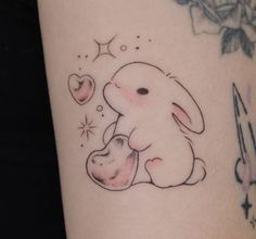 a tattoo with a bunny holding a heart