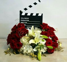 red roses and white lilies in front of a clap board