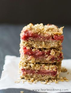 three strawberry crumbled bars stacked on top of each other