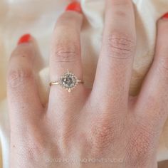 a woman's hand with a diamond ring on it