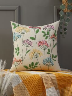 a white pillow with colorful flowers on it